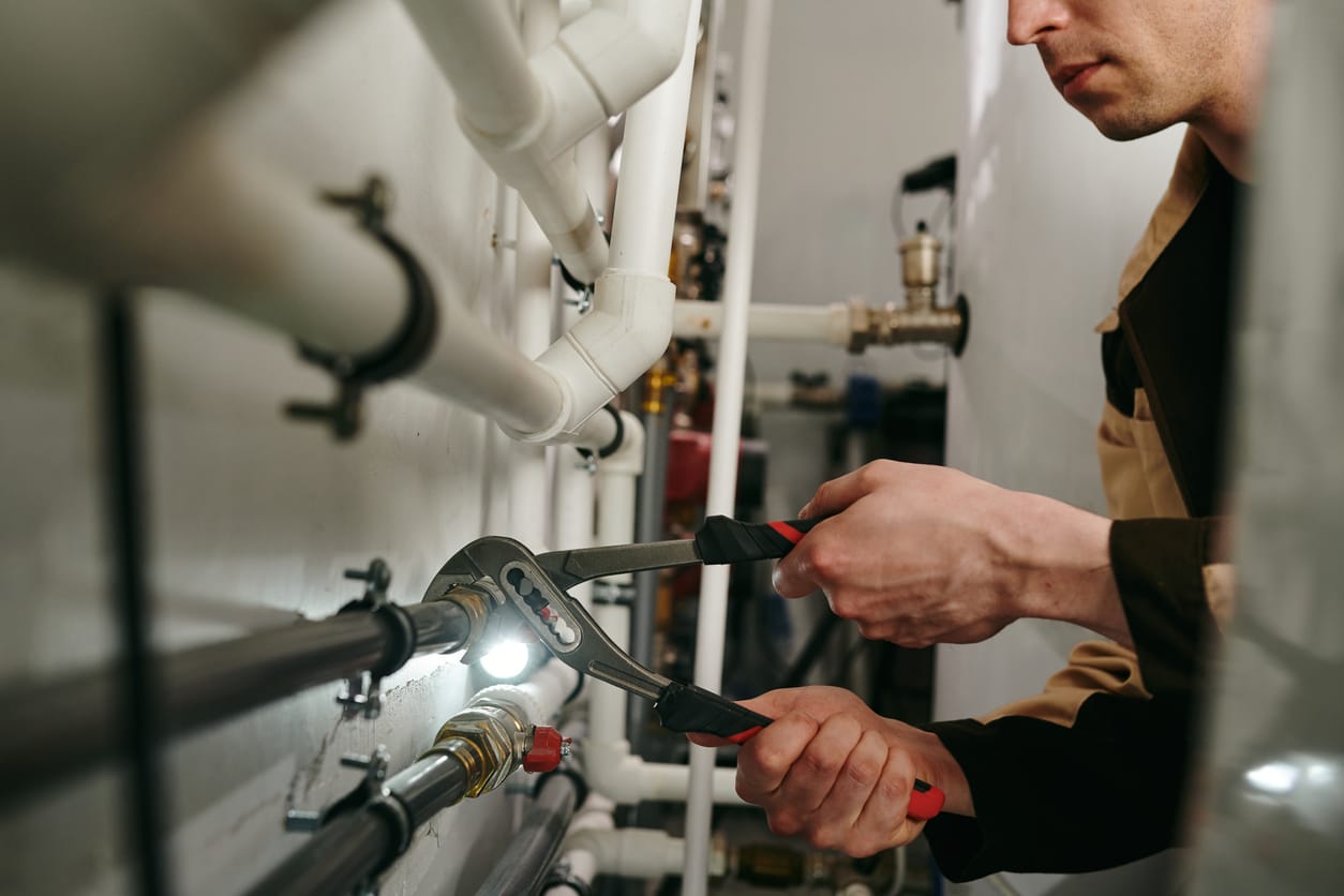 Plumbers maintaining commercial plumbing pipes in Lafayette