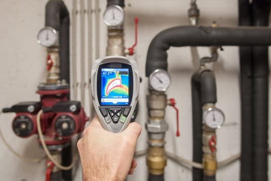 Plumber using a thermal imaging camera to inspect pipes in Lafayette