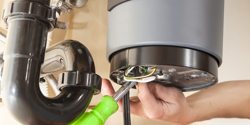 Technician repairing the heating element of a water heater in Lafayette