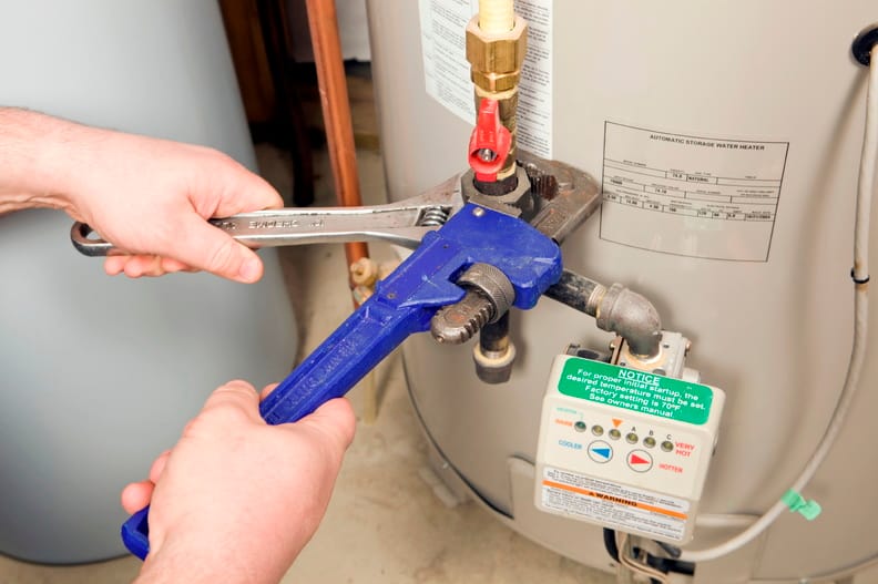 Plumber repairing a water heater valve in Lafayette